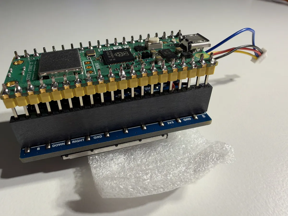The Pico sitting too high on the screen board, silver pins showing under it