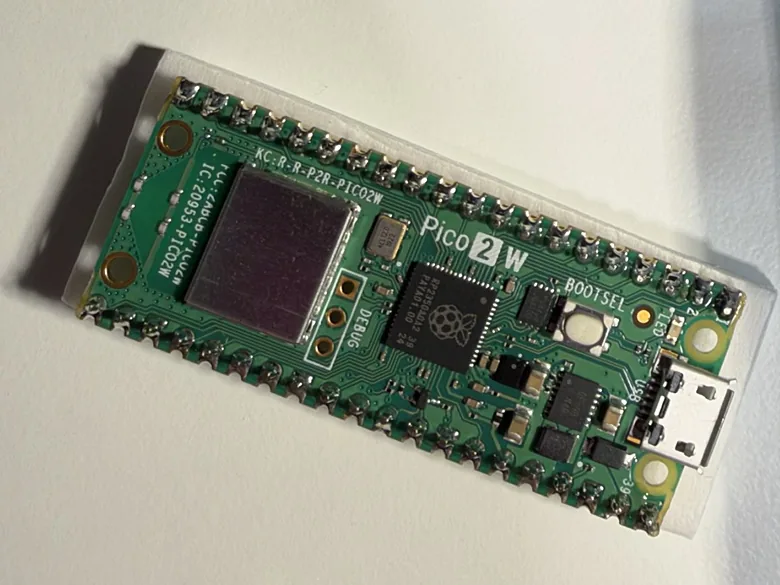 A Raspberry Pi Pico 2 W board with its pins soldered